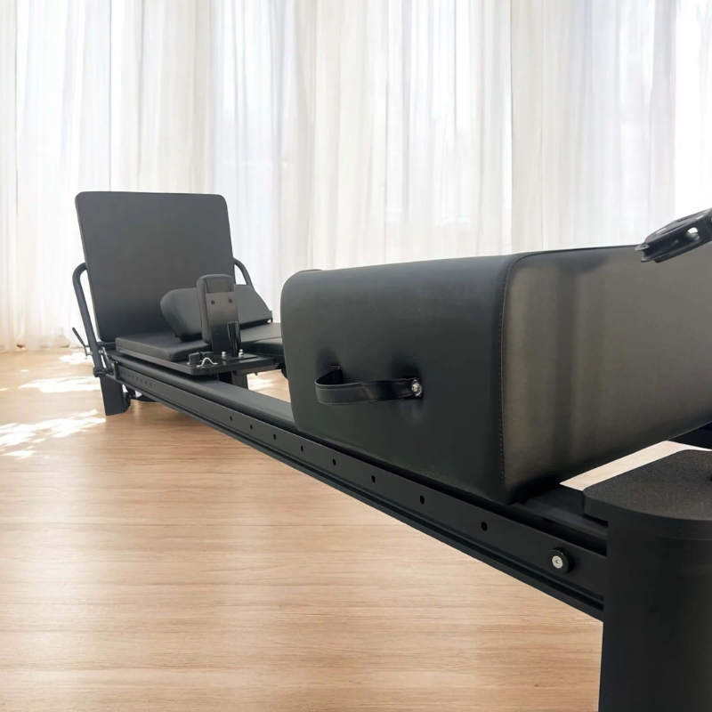 Left side of the Core Collab Full Track Queen Studio Reformer Pilates Machine in Black colour