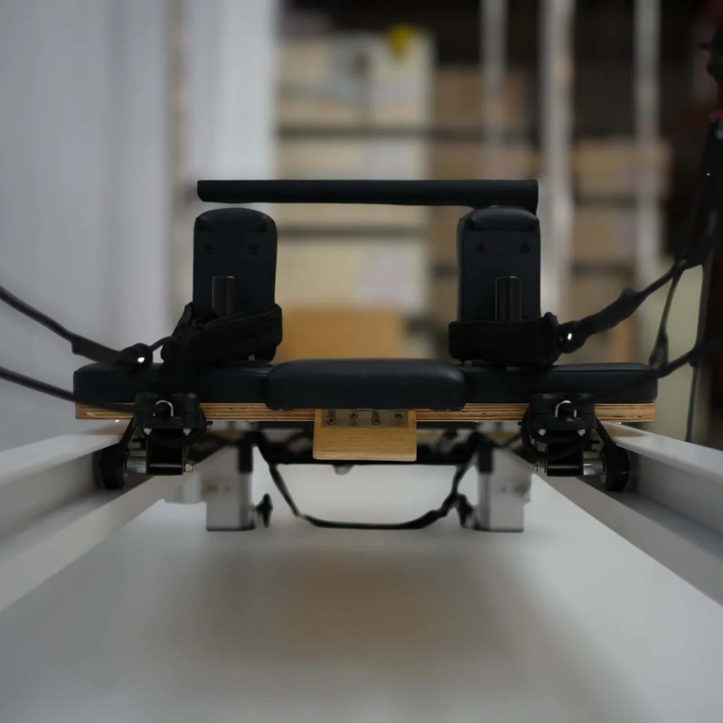 Front close-up view of the carriage on Core Collab Queen Pilates Cadillac Reformer