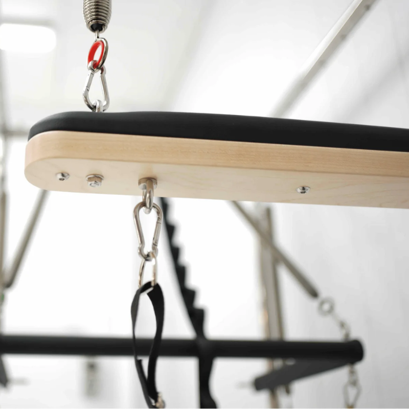 Bottom view of the push-through bar on Core Collab Queen Cadillac Pilates Reformer with full trapeze frame