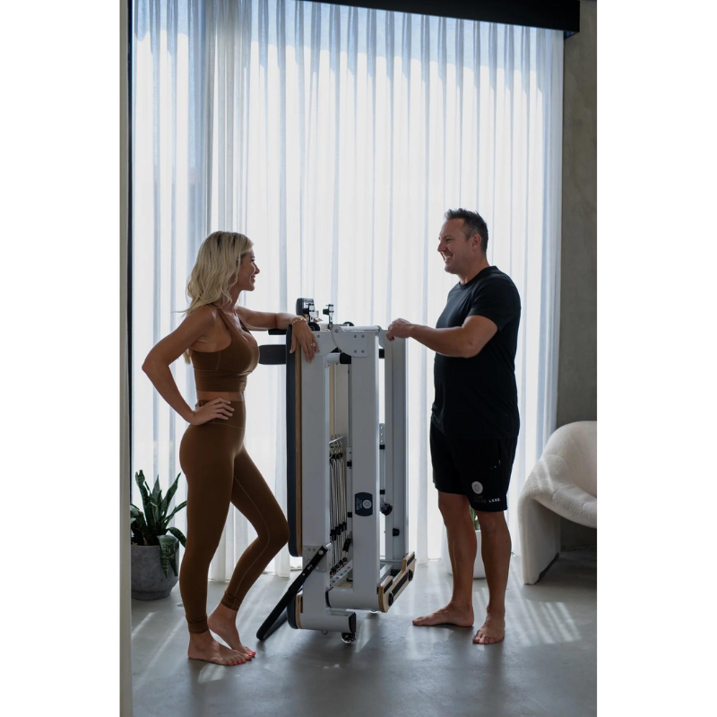 Woman and Man Standing by Core Collab The Queen Folding Pilates Reformer