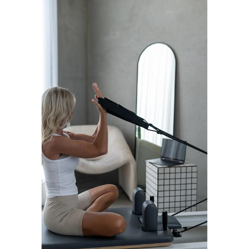 Woman Using Core Collab The Queen Folding Pilates Reformer