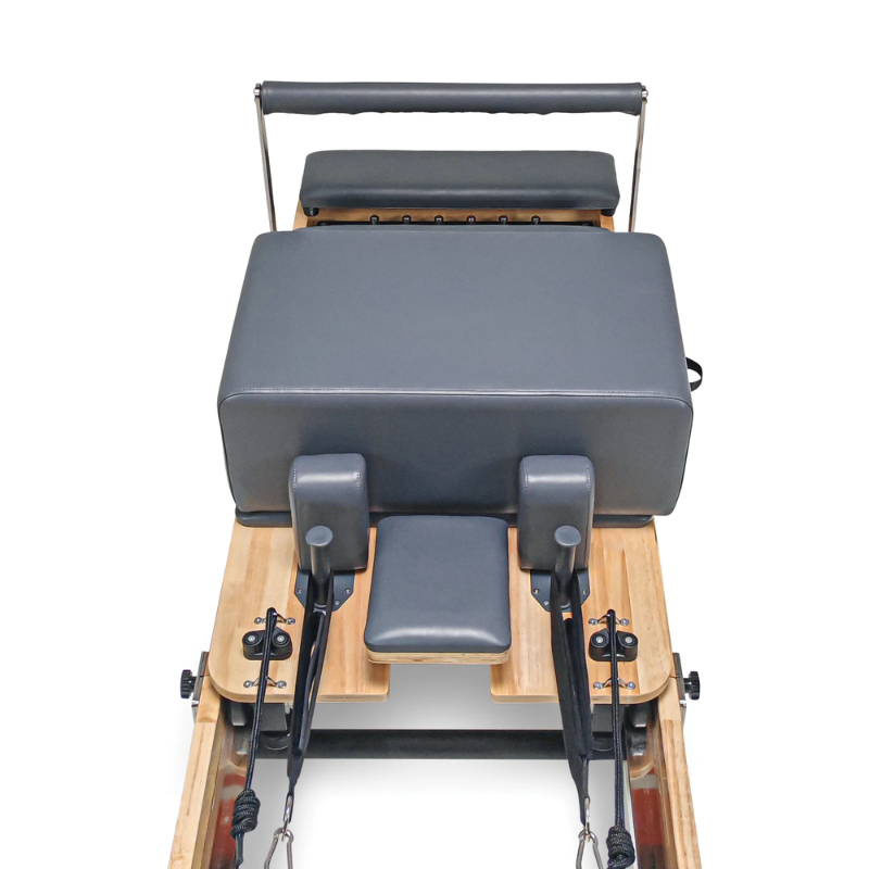 Close-up of the carriage and sitting box on the Impact Fitness Folding Pilates Reformer in Dark Grey colour