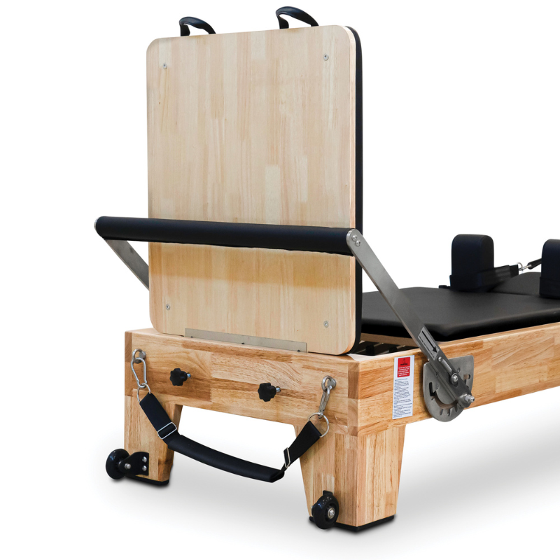 Front of the Impact Fitness Oak Wood Pilates Reformer Machine with jump board on