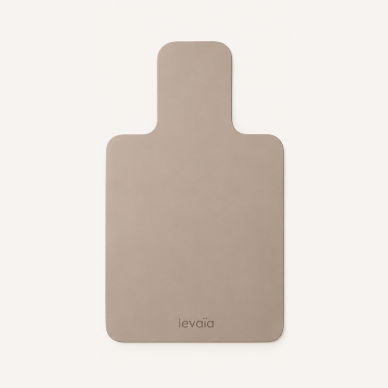 levaïa Pilates Reformer Mat in Taupe laid flat, with rounded corners, a narrow headrest extension and the levaïa logo near the bottom.