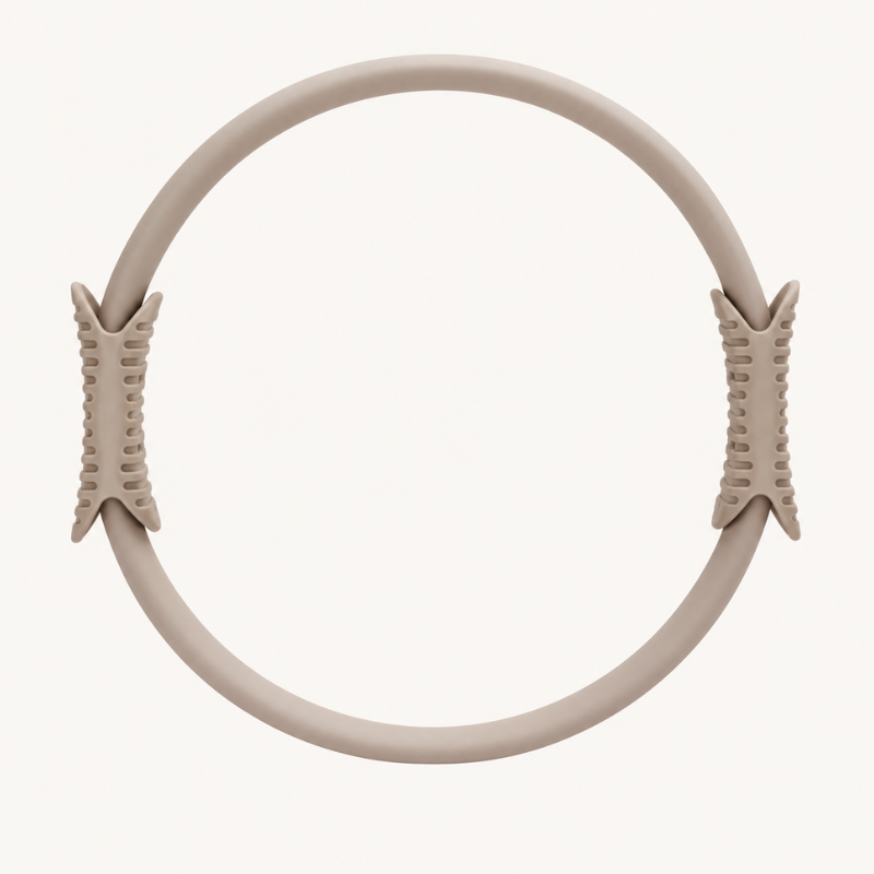 levaïa Pilates Ring in Taupe, showing its circular design with two textured handles on opposite sides against a white background.