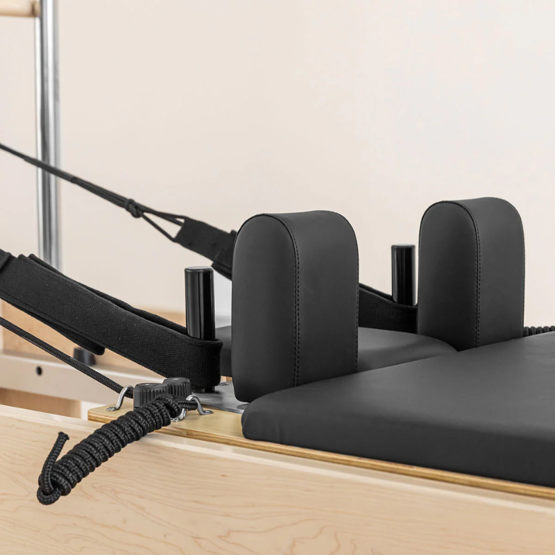 Close-up of the carriage and hand and feet loops on the Lifespan Fitness Contour Cadillac Reformer with Full Trapeze