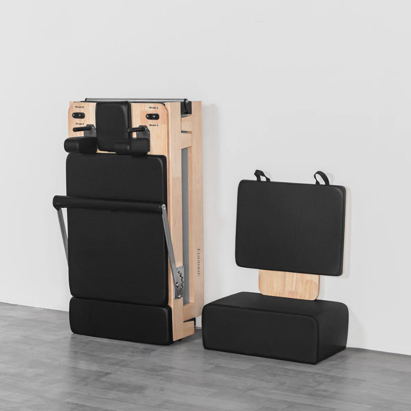 Folded state of the contour folding wooden pilates reformer machine and its sitting box and jumpboard