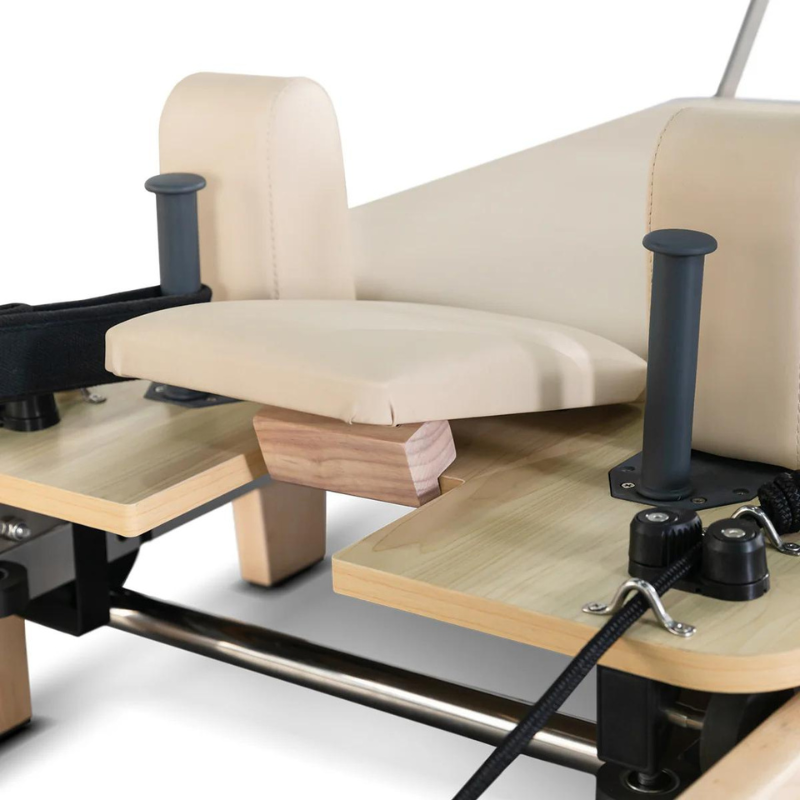 Close-up of the head rest tilted up on the Contour folding wooden pilates reformer machine in Beige