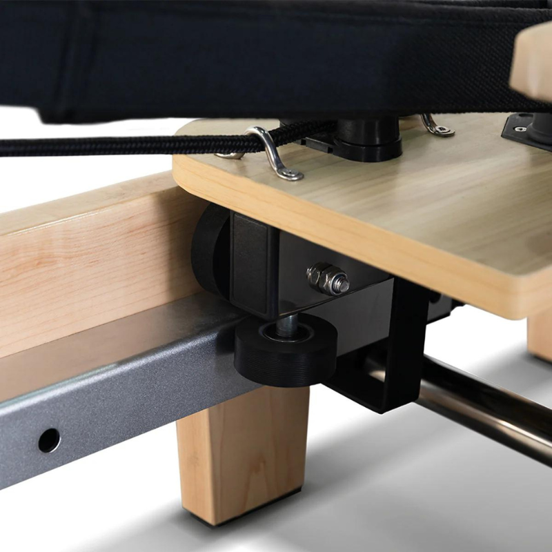 Close-up of the carriage rollers on the Contour folding wooden pilates reformer machine in Beige