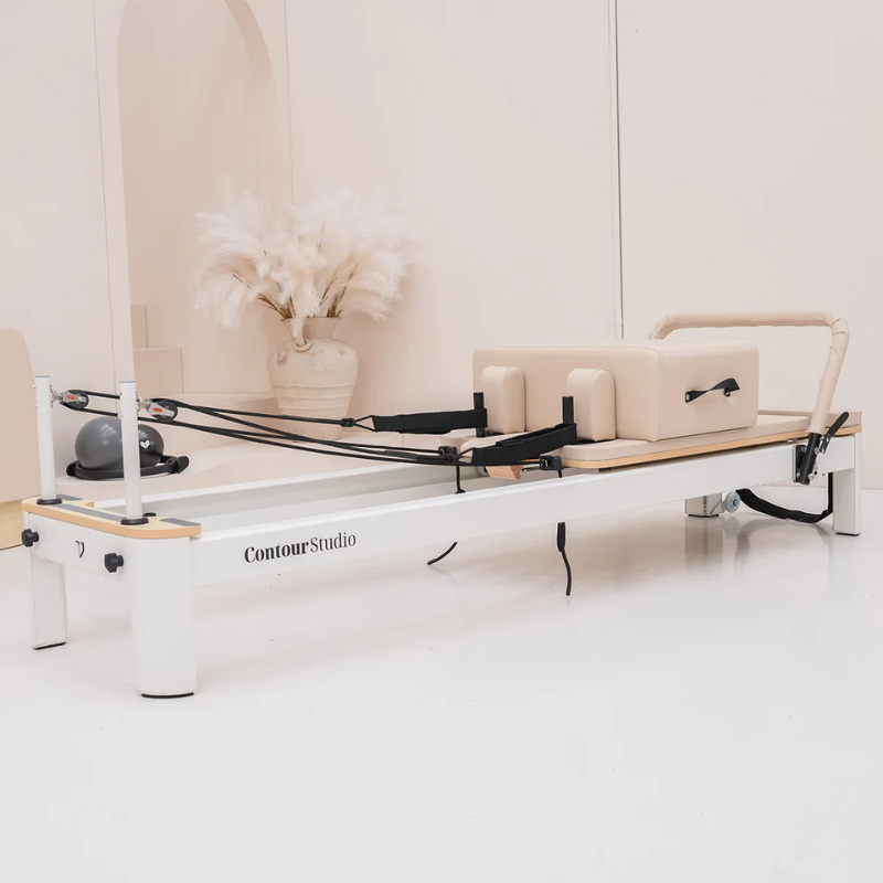 Lifespan Fitness Contour Studio Commercial Pilates Reformer Machine in Beige inside a minimalistic studio room.