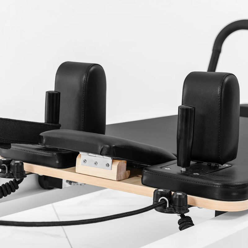 Close-up of the head and shoulder rests on the Lifespan Fitness Contour Studio Commercial Pilates Reformer Machine in Black colour