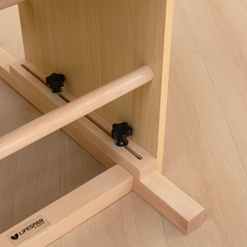 Close-up of the bottom adjustable screws on the Lifespan Fitness Pilates Ladder Barrel