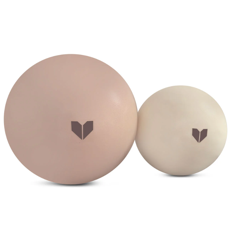 Two balls positioned side by side from the Lifespan Fitness Pilates Ring + Small and Medium Pilates Balls Pack in Seashell