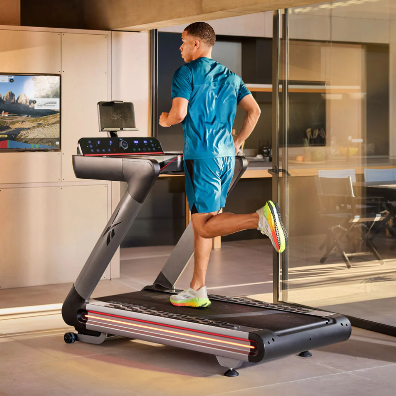 Back view of a man running on the Reebok Treadmill