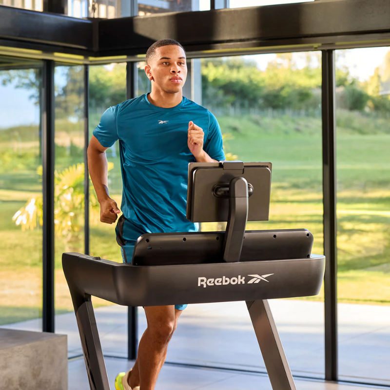 Front view of a man running on the Reebok Treadmill