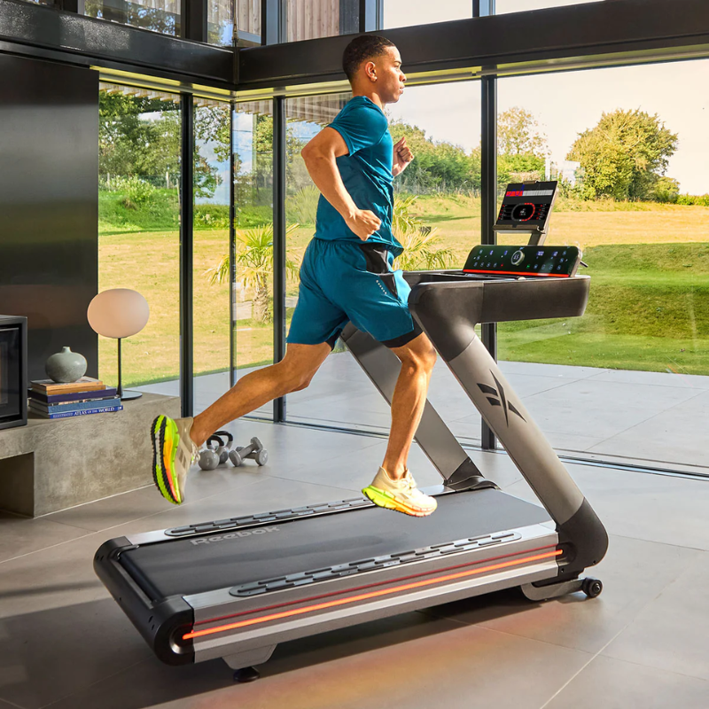 Side view of a man running on the Reebok Z Tech Treadmill