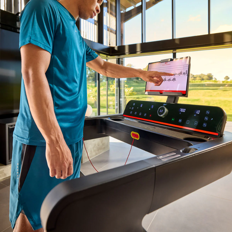 A man using the control screen on the Reebok Z Tech Treadmill