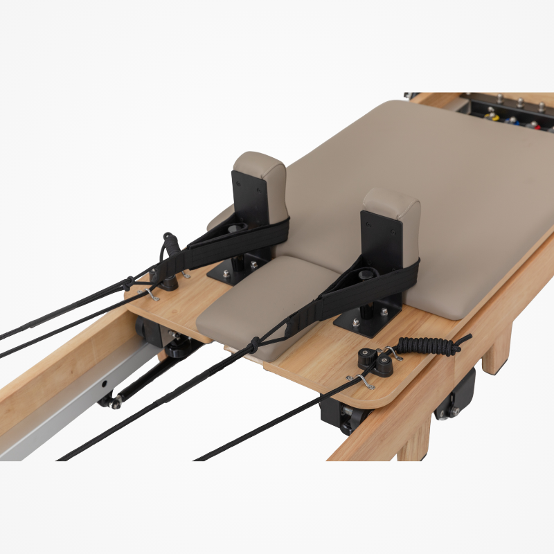 Back view of the carriage bed and shoulder blocks on Reformys Cloud Folding Pilates Reformer Machine in Beige