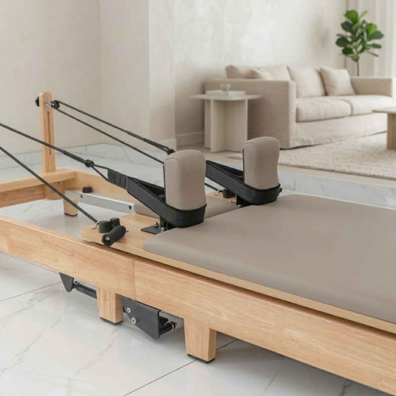 Closeup of carriage of Reformys Cloud Hydraulic-Assisted Folding Pilates Reformer Machine in Beige inside a home lounge