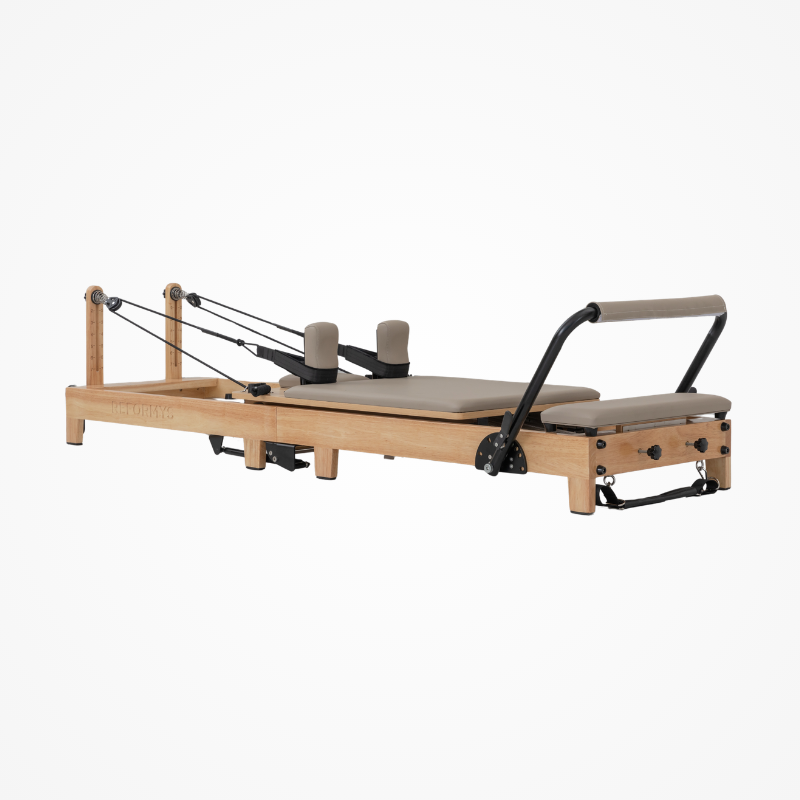 Front right angled view of the Reformys Cloud Foldable Pilates Reformer in Beige