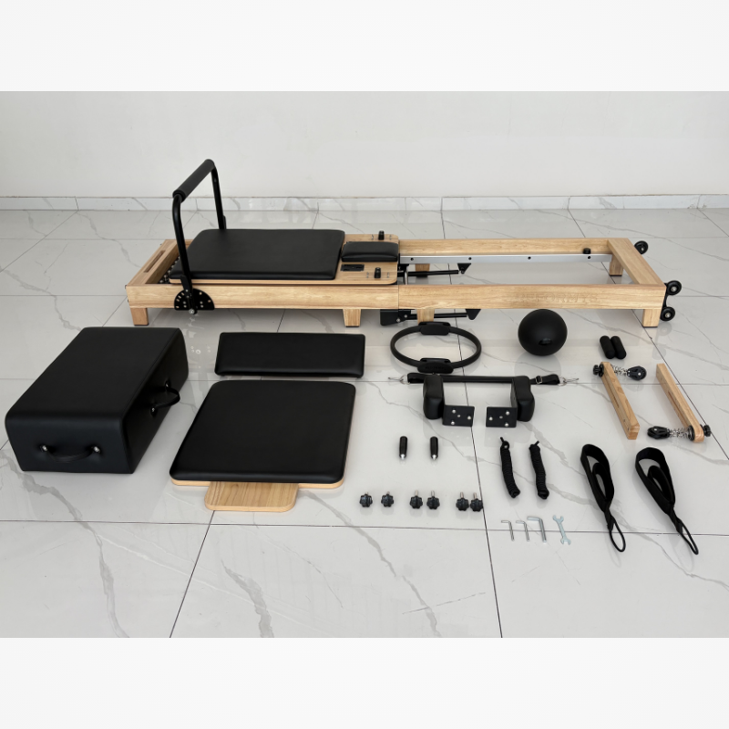 Flat lay of all included accessories and parts for Reformys Cloud Foldable Pilates Reformer in Black