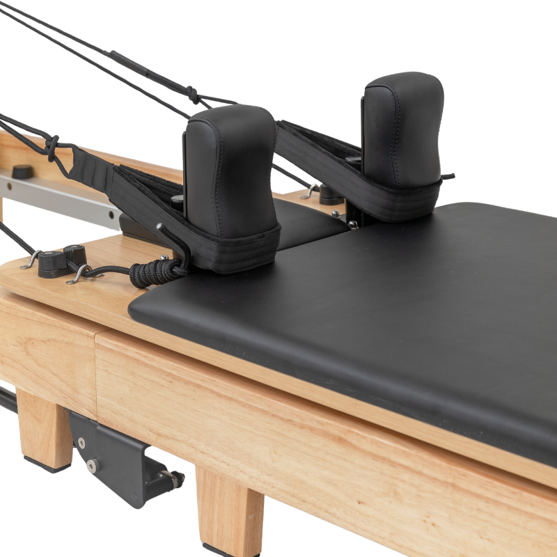 Close-up of the shoulder blocks and carriage bed on Reformys Cloud Folding Pilates Reformer Machine in Black