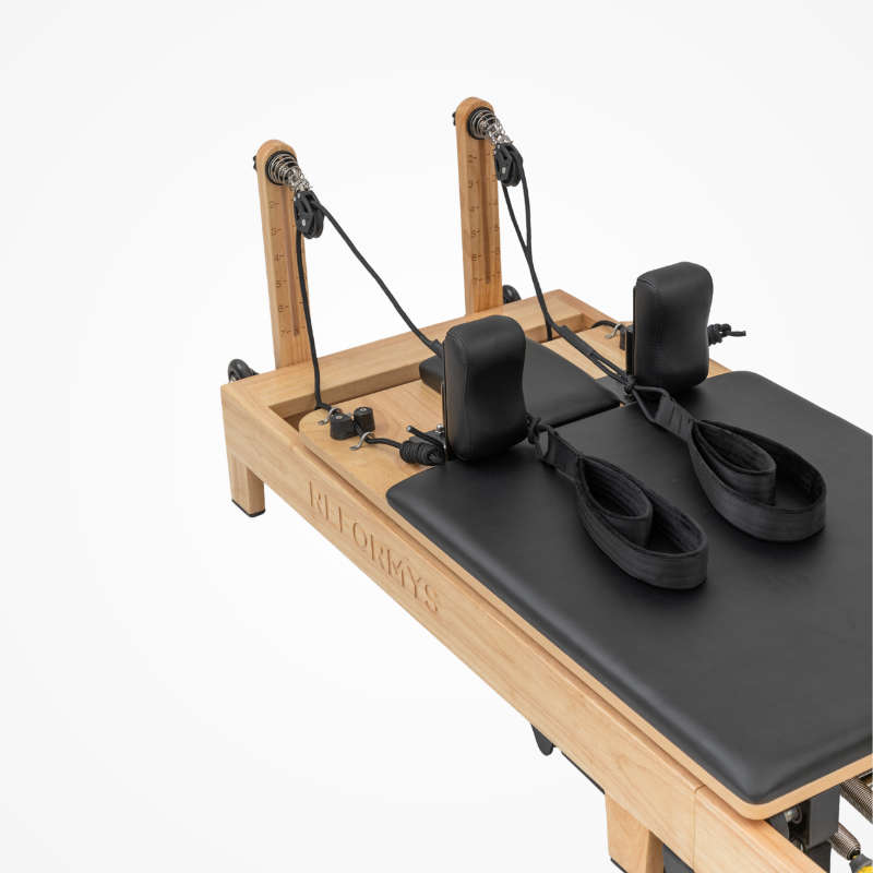 Closer view of the double-loop handles sitting on the carriage bed of Reformys Cloud Folding Pilates Reformer in Black