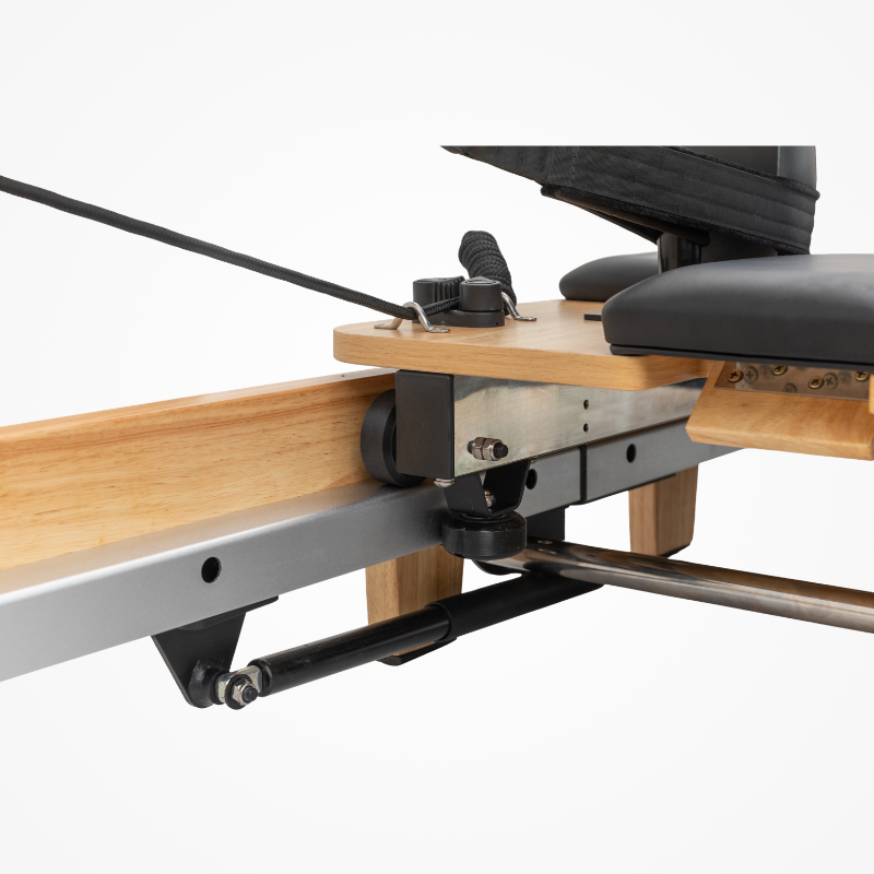 Close-up of the hydraulic damping lever and carriage rail of Reformys Cloud Foldable Pilates Reformer in Black