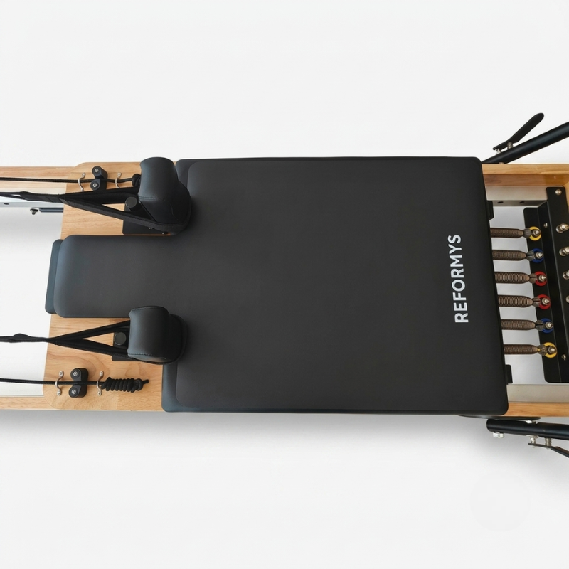 Reformys Pilates Reformer Mat in Black on a reformer Pilates machine with white background