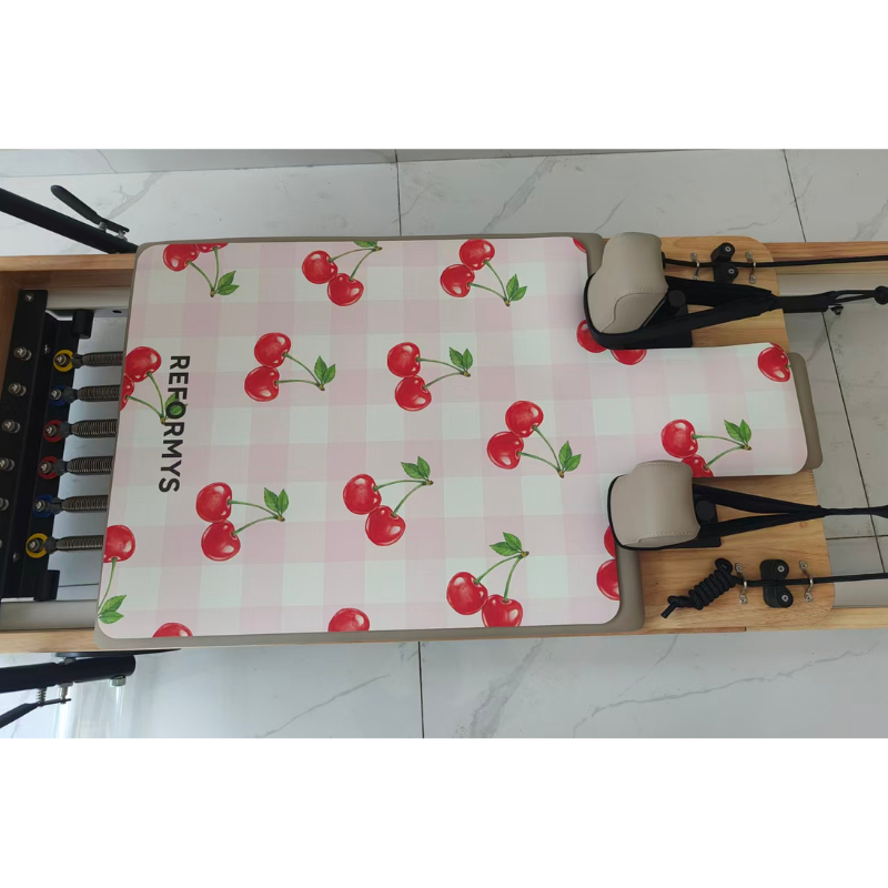 Closer view of the Reformys Pilates Reformer Mat in Cherry Crush on a Pilates reformer machine