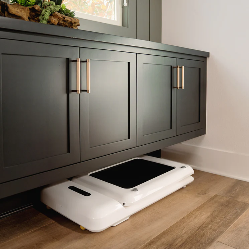 WalkingPad C2 Compact Folding Treadmill in White stored away under a cabinet