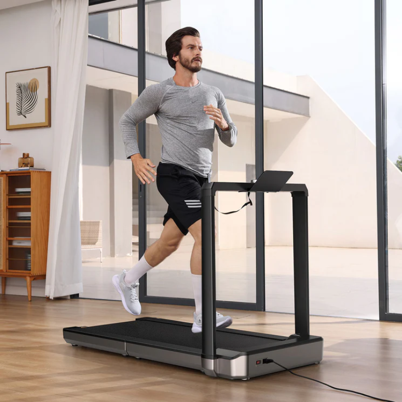 Man running on the WalkingPad MX16 Double-Fold Treadmill in a modern living room.