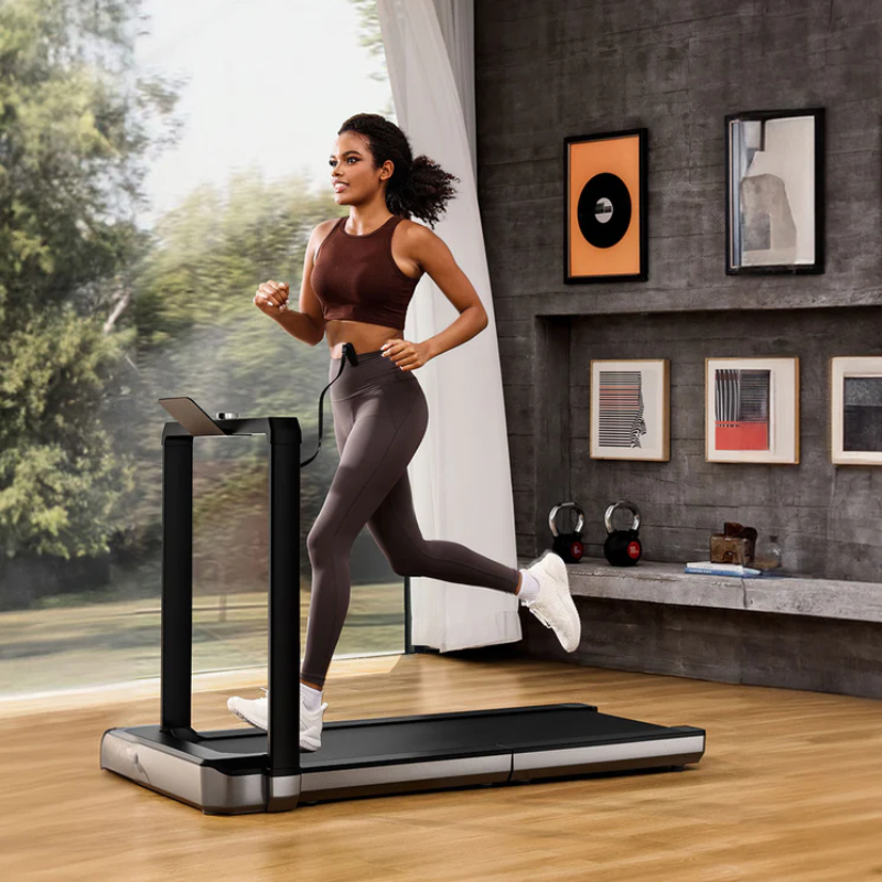 Woman running on the WalkingPad MX16 Folding Treadmill in a modern lounge