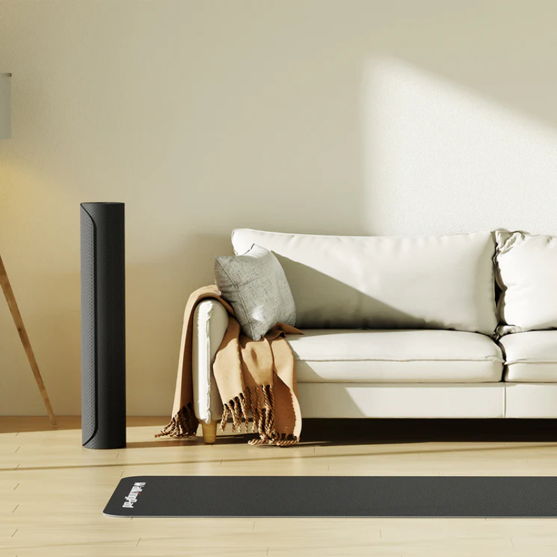 WalkingPad Treadmill Mat in Small size laid on wooden floor inside a modern living room