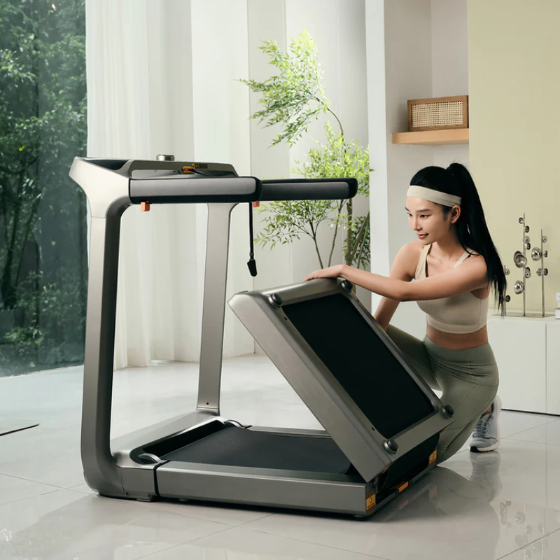 Woman folding out the second part of the WalkingPad X218 Double-Fold Treadmill