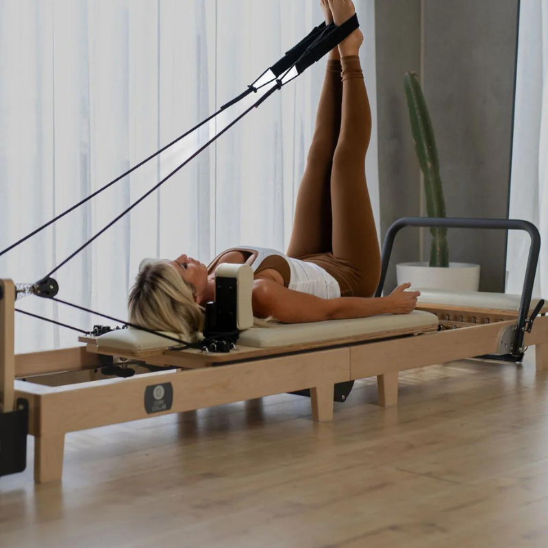 Woman Using Core Collab Eco Warrior Foldable Pilates Reformer