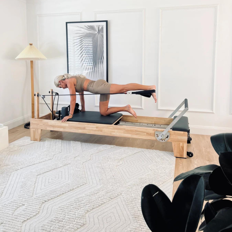 Woman Using Core Collab The Eco Warrior Pilates Reformer