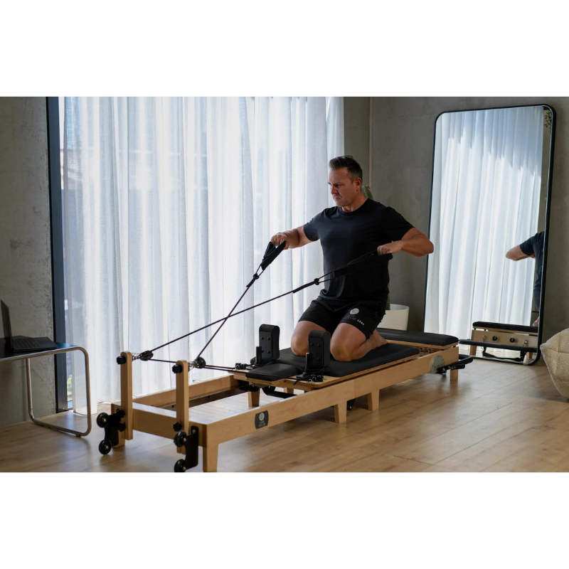 Man Using Core Collab Foldable Eco Pilates Reformer - Customised by You in Black