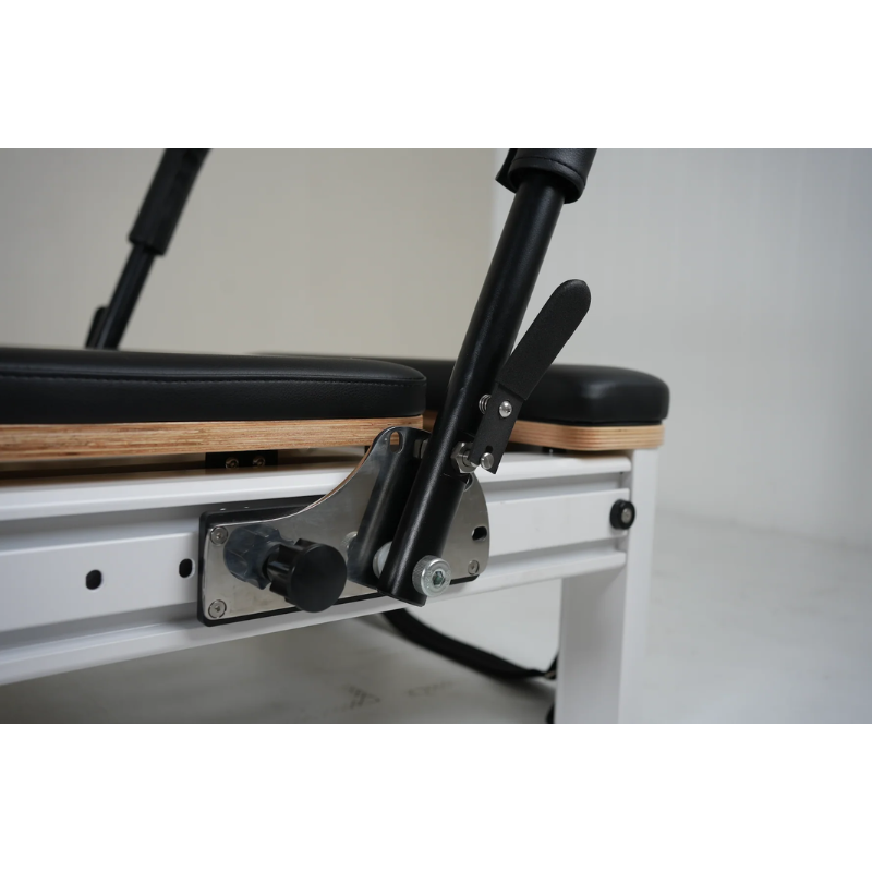 Close-up of the footbar on Core Collab Full Track Queen Studio Pilates Reformer Machine in White Frame and Black Upholstery