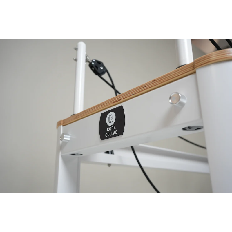 Close-up of the logo plate on Core Collab Full Track Queen Studio Pilates Reformer Machine in White Frame