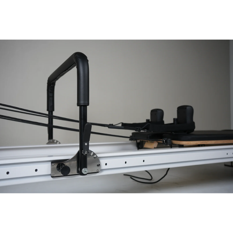 Close-up of the full-track frame on the Core Collab Full Track Queen Studio Pilates Reformer Machine in White Frame and Black Upholstery