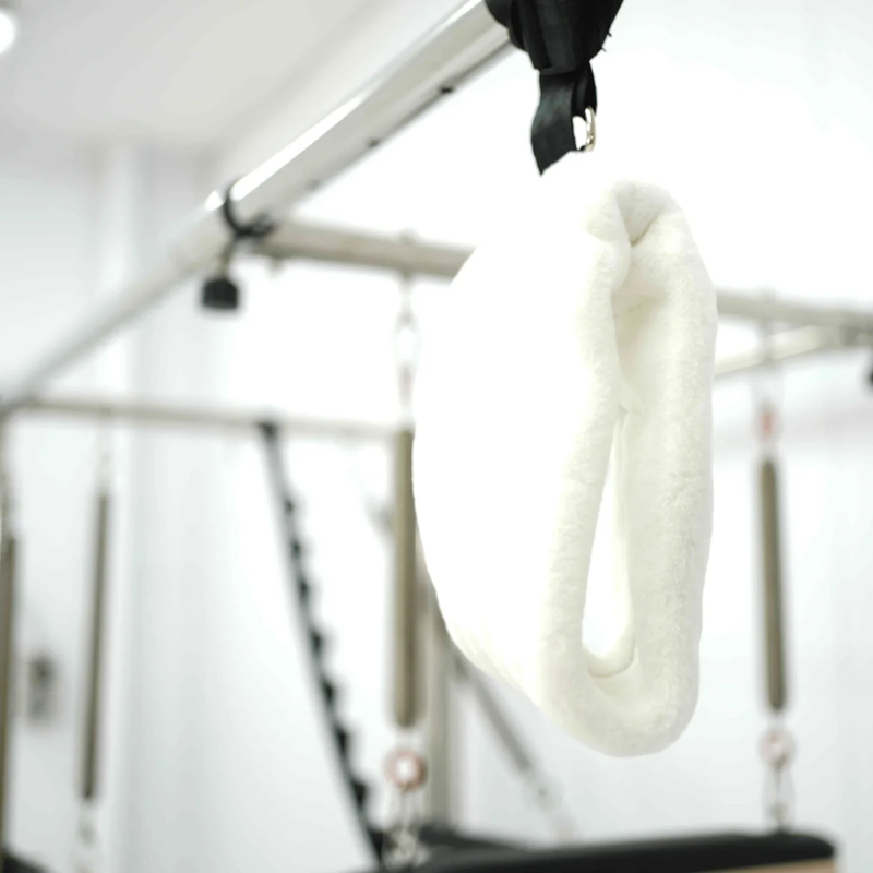 Close-up of a fuzzy loop on the Core Collab Queen Cadillac Reformer with full trapeze frame