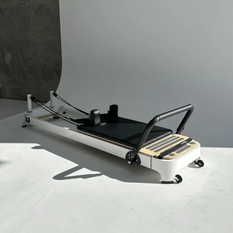 Front side angle view of the Core Collab Queen Studio 2.0 Reformer Pilates Machine in Black