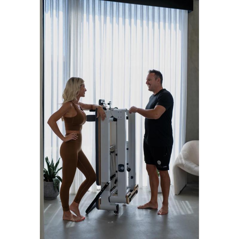 Woman and Man Standing by Core Collab The Queen Folding Pilates Reformer 