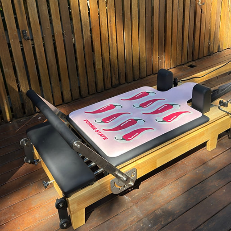 Forme State Pilates Reformer Mat in Chilli at a home backyard
