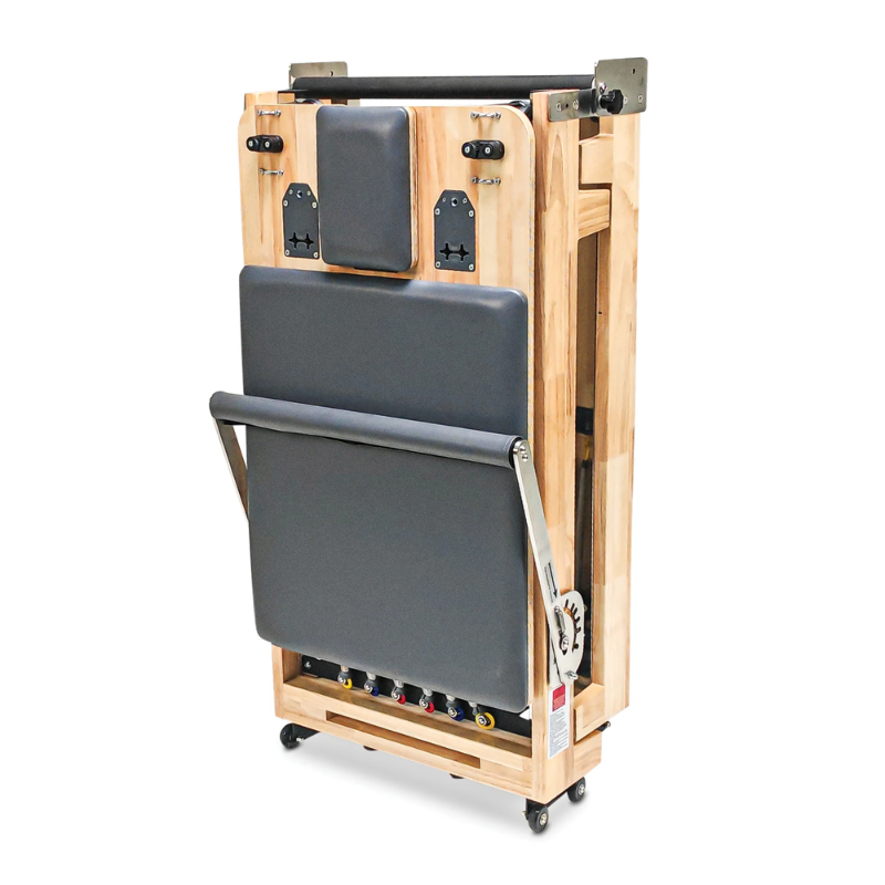 Impact Fitness Folding Pilates Reformer Machine in Dark Grey colour and folded upright