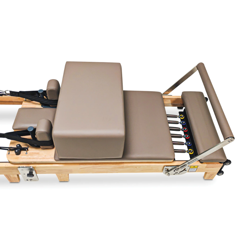 Close-up of the carriage and sitting box on the Impact Fitness Foldable Reformer Pilates Machine in Mocha colour