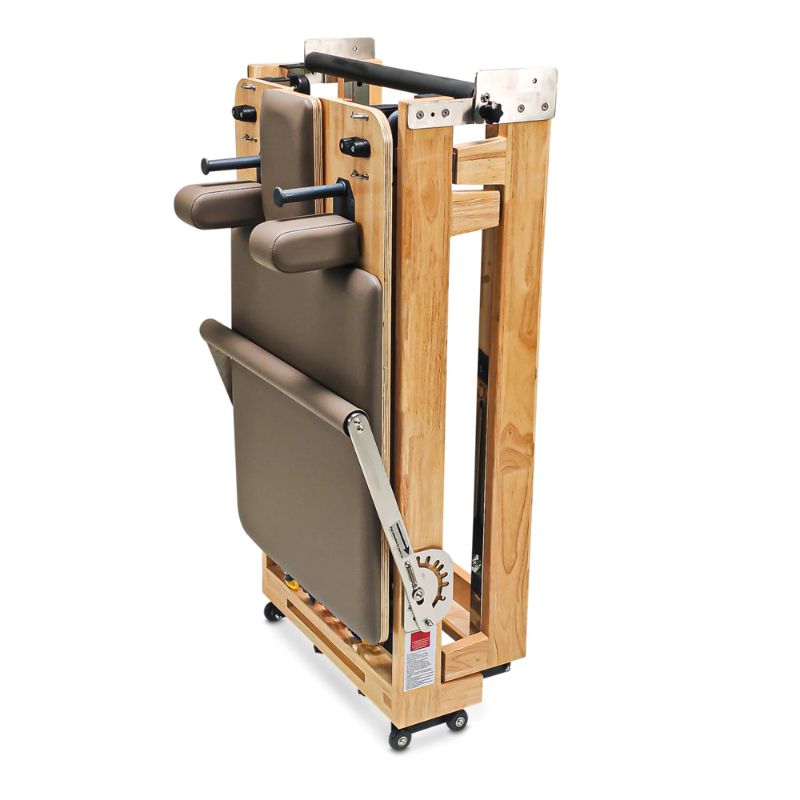 Impact Fitness Foldable Pilates Reformer Machine in Mocha colour and folded upright