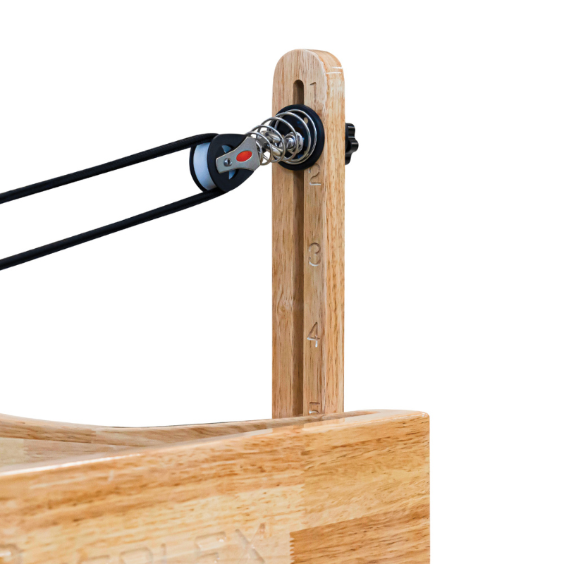 Close-up of the rope pulley on the Impact Fitness Oak Wood Pilates Reformer Machine