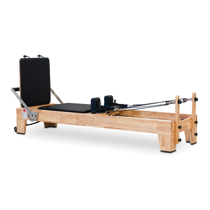 Side angle view of Impact Fitness Oak Wood Pilates Reformer Machine